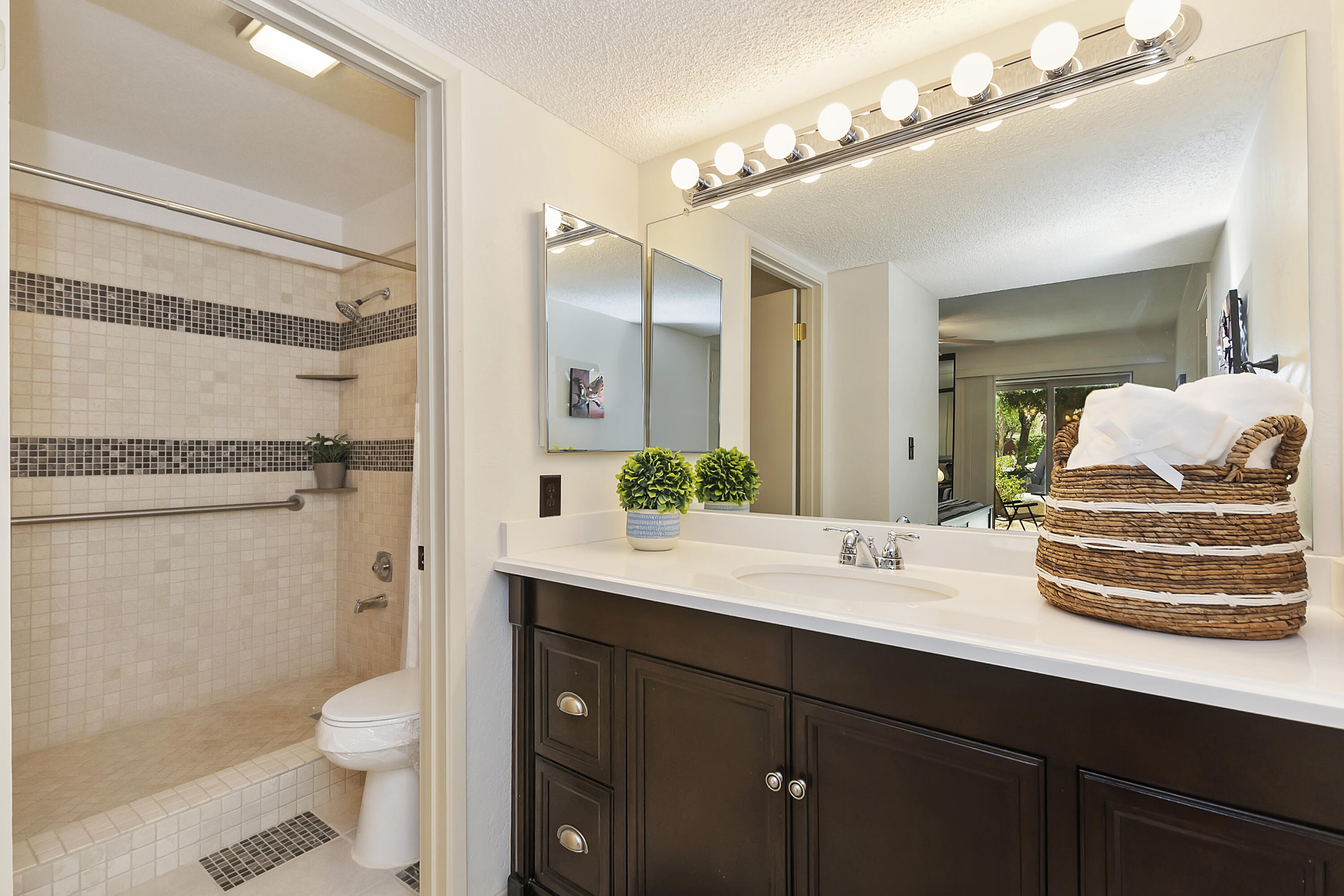 48255 Monroe Street, Unit 6 Indio, CA 92201 - Photo 11 of 43 a bathroom with a granite countertop sink toilet mirror and shower