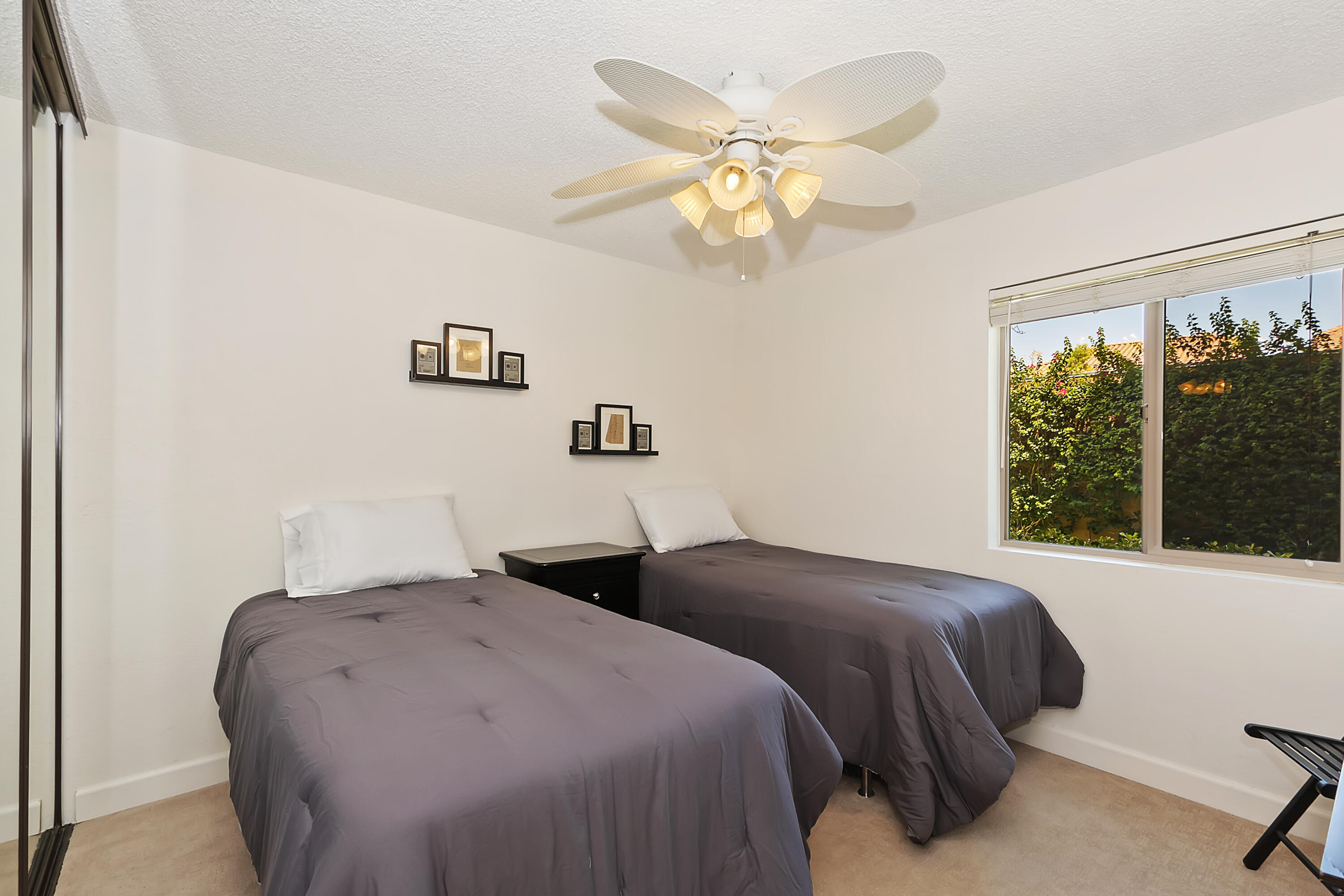 48255 Monroe Street, Unit 6 Indio, CA 92201 - Photo 13 of 43 a bedroom with a large bed and a window