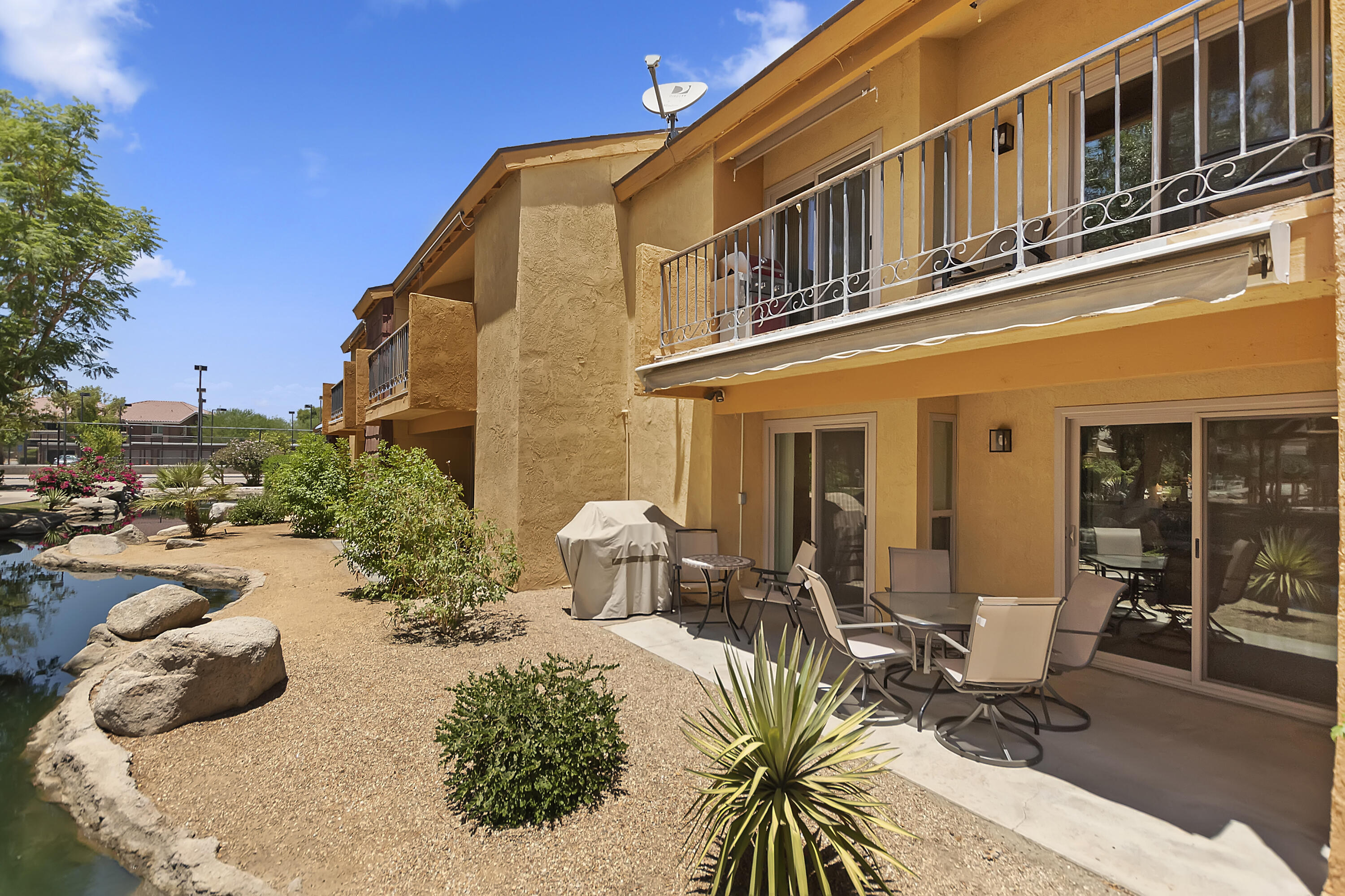 48255 Monroe Street, Unit 6 Indio, CA 92201 - Photo 19 of 43 a building outdoor space with patio furniture and potted plants