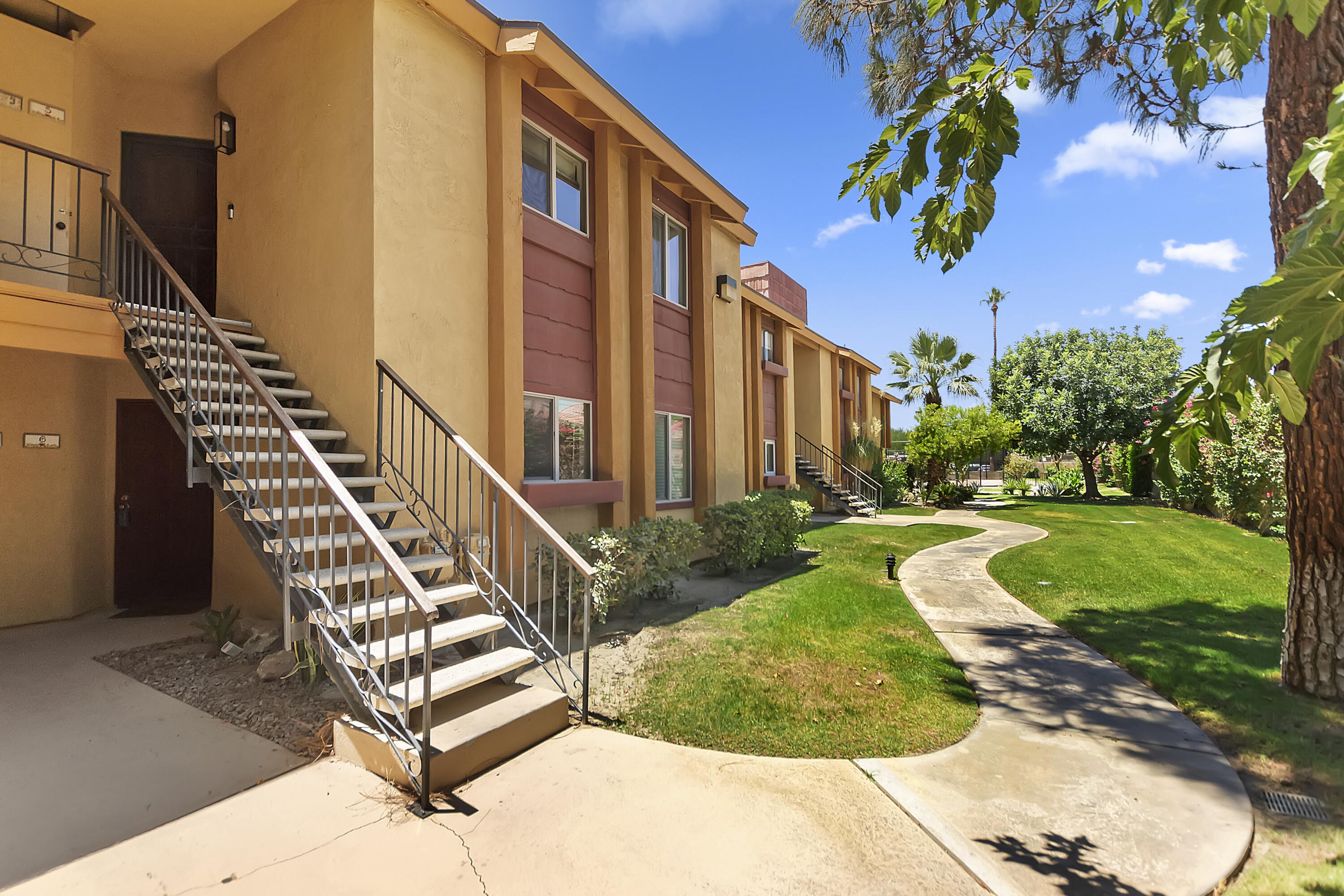 48255 Monroe Street, Unit 6 Indio, CA 92201 - Photo 22 of 43 a view of a building with a yard