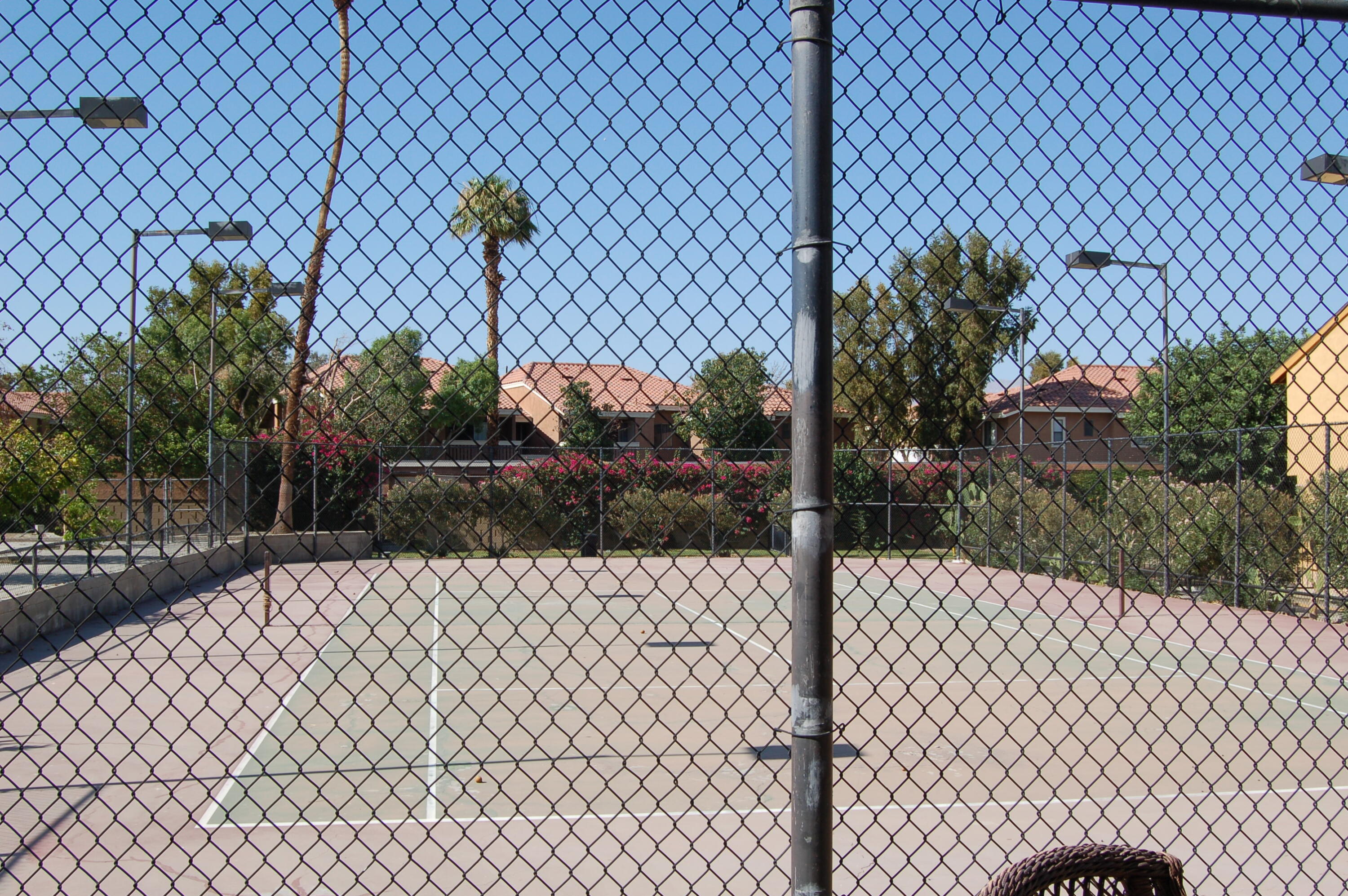 48255 Monroe Street, Unit 6 Indio, CA 92201 - Photo 31 of 43 a street view with a fence