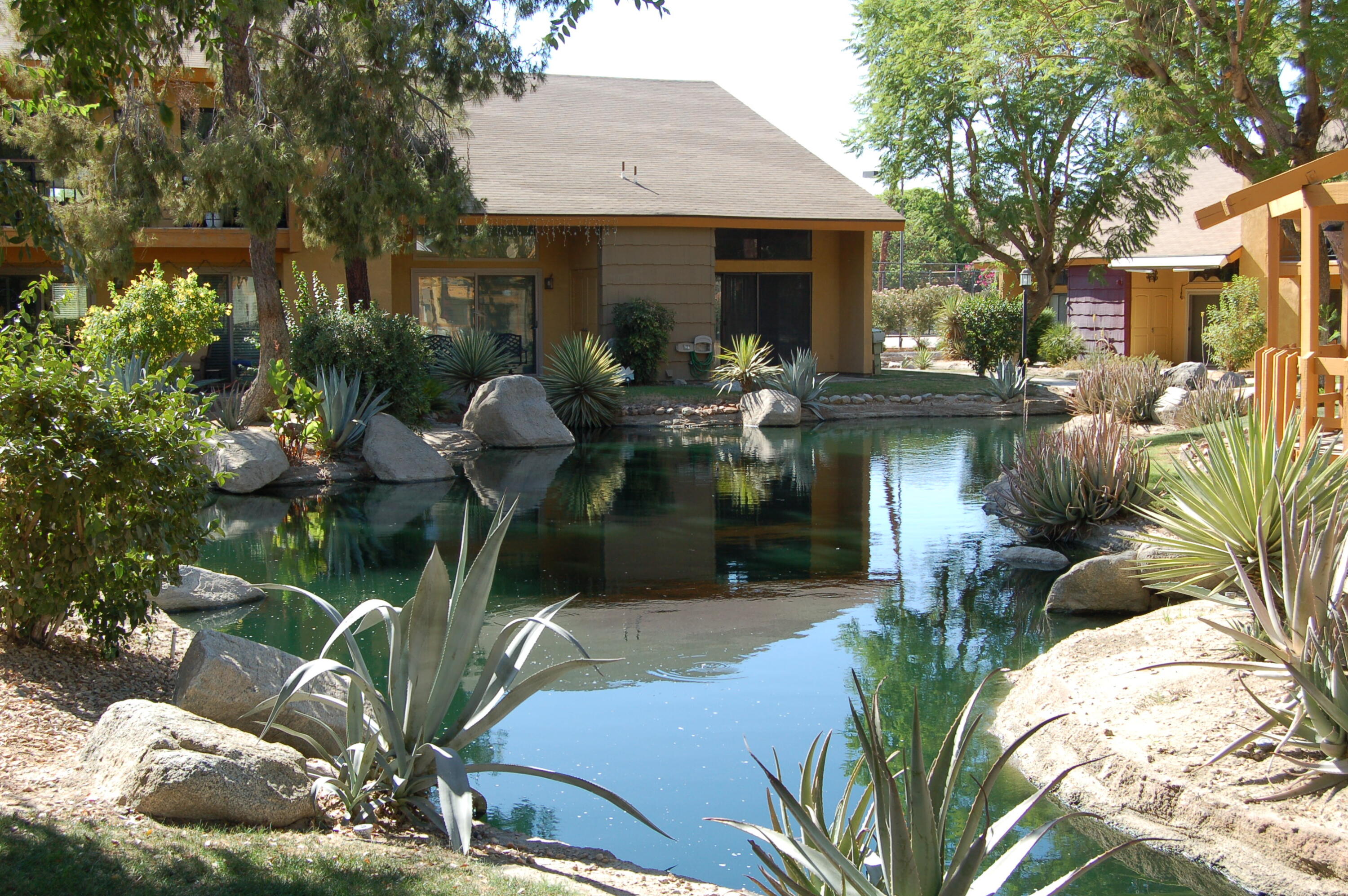 48255 Monroe Street, Unit 6 Indio, CA 92201 - Photo 42 of 43 a front view of a house with fountain bath tub and fire pit