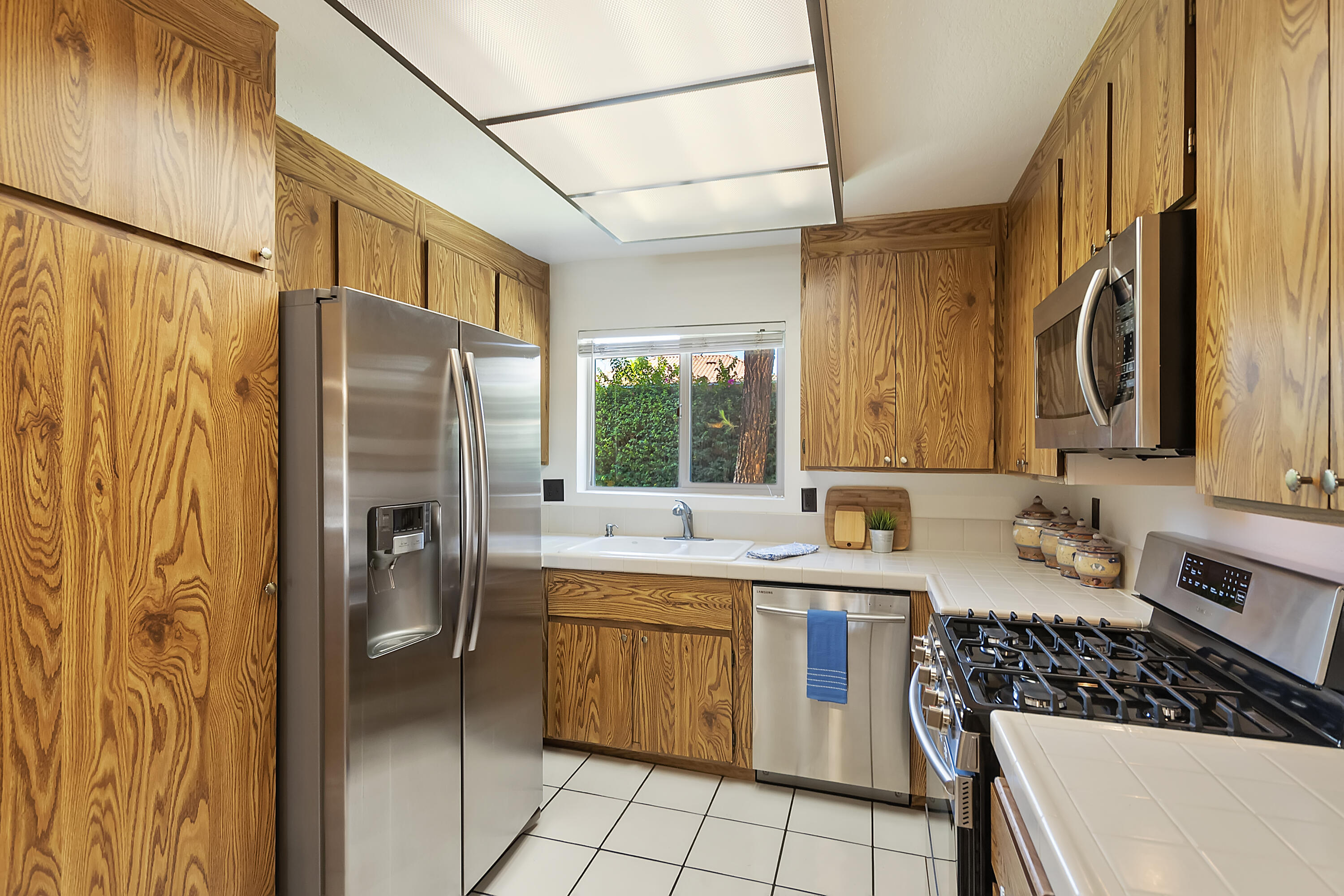 48255 Monroe Street, Unit 6 Indio, CA 92201 - Photo 5 of 43 a kitchen with a sink stove and refrigerator