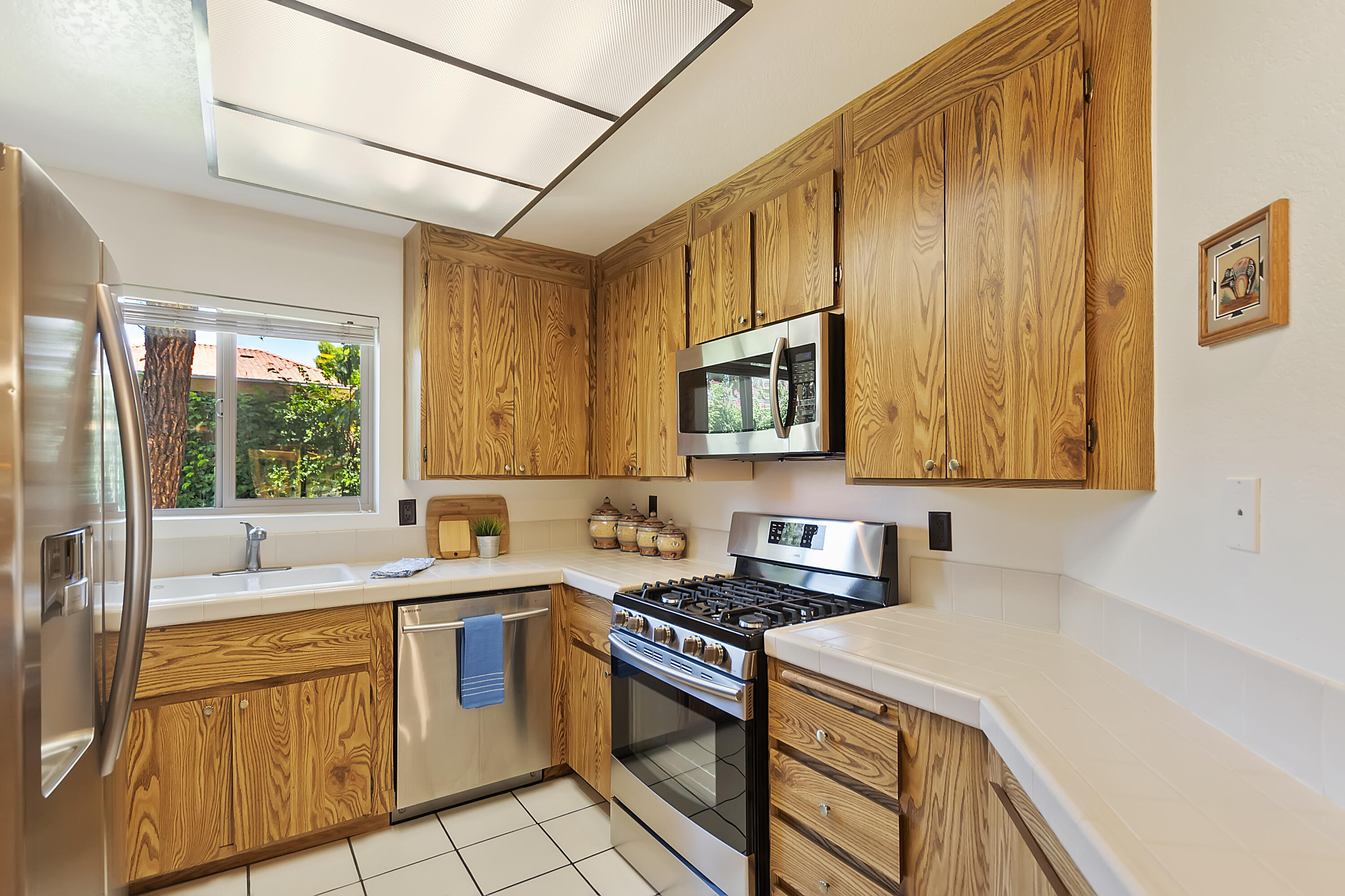 48255 Monroe Street, Unit 6 Indio, CA 92201 - Photo 6 of 43 a kitchen with stainless steel appliances granite countertop a sink and a stove