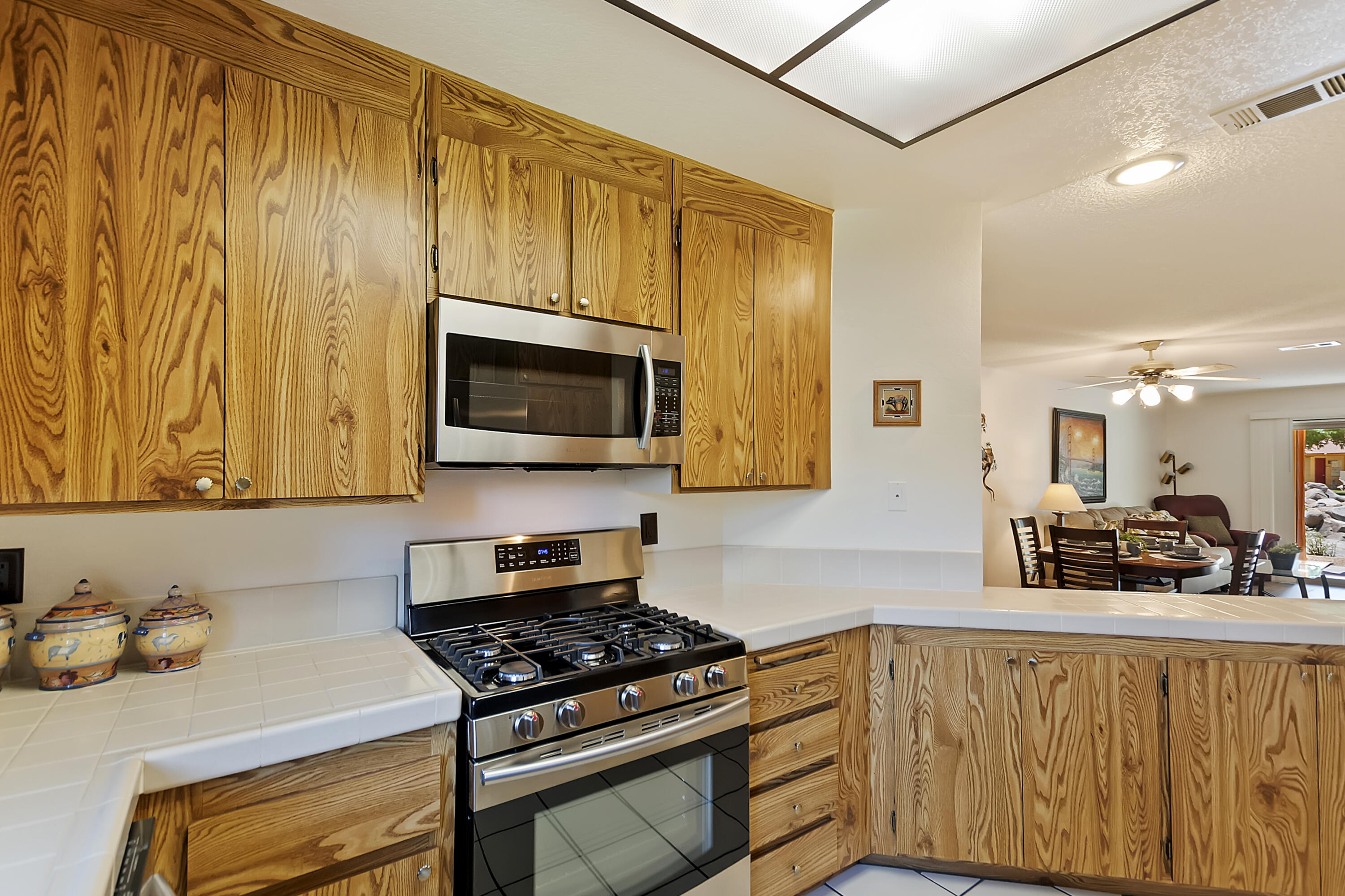 48255 Monroe Street, Unit 6 Indio, CA 92201 - Photo 7 of 43 a kitchen with stainless steel appliances a stove a microwave a sink and cabinets