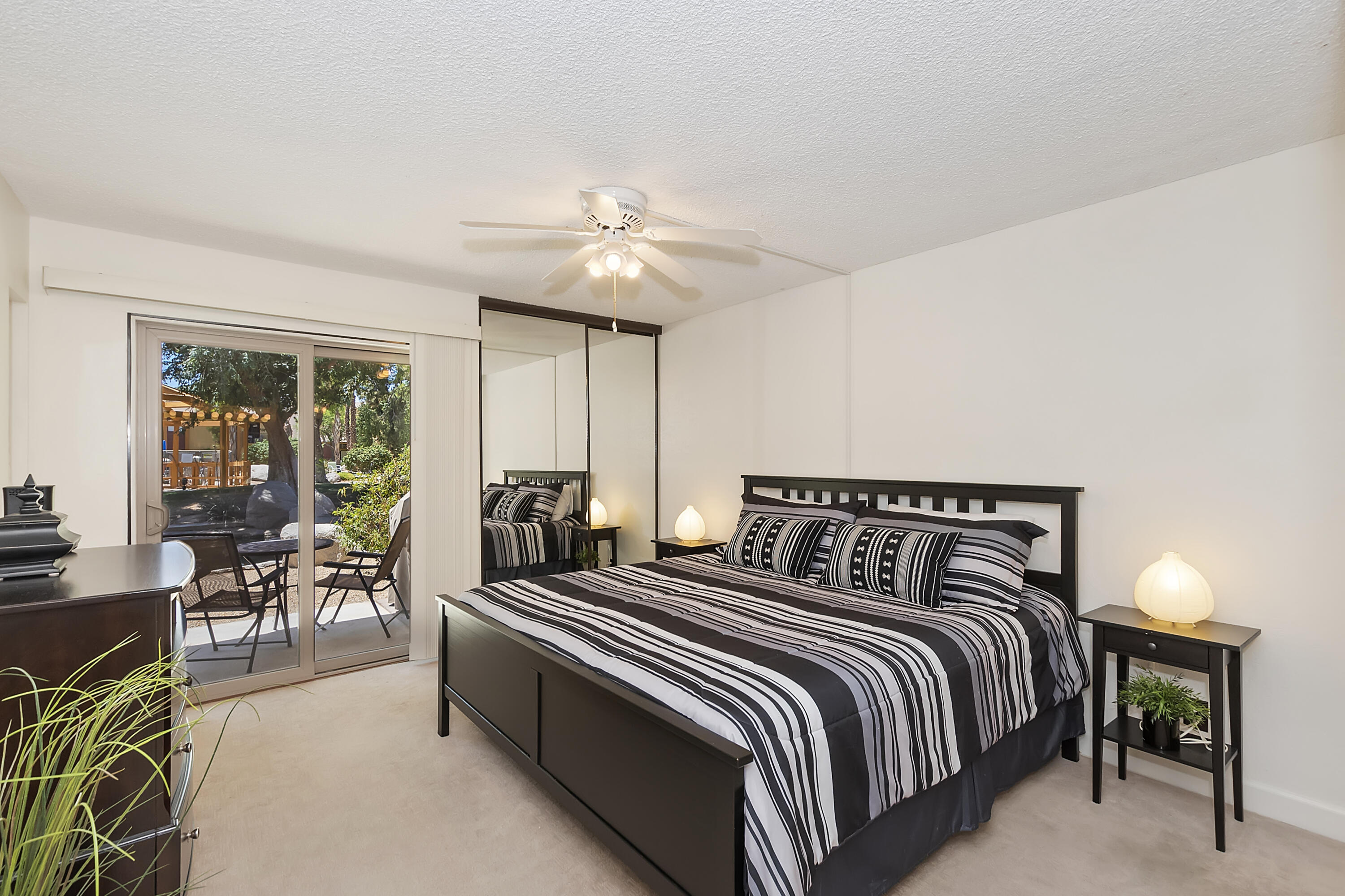 48255 Monroe Street, Unit 6 Indio, CA 92201 - Photo 8 of 43 a bedroom with two beds and a chandelier
