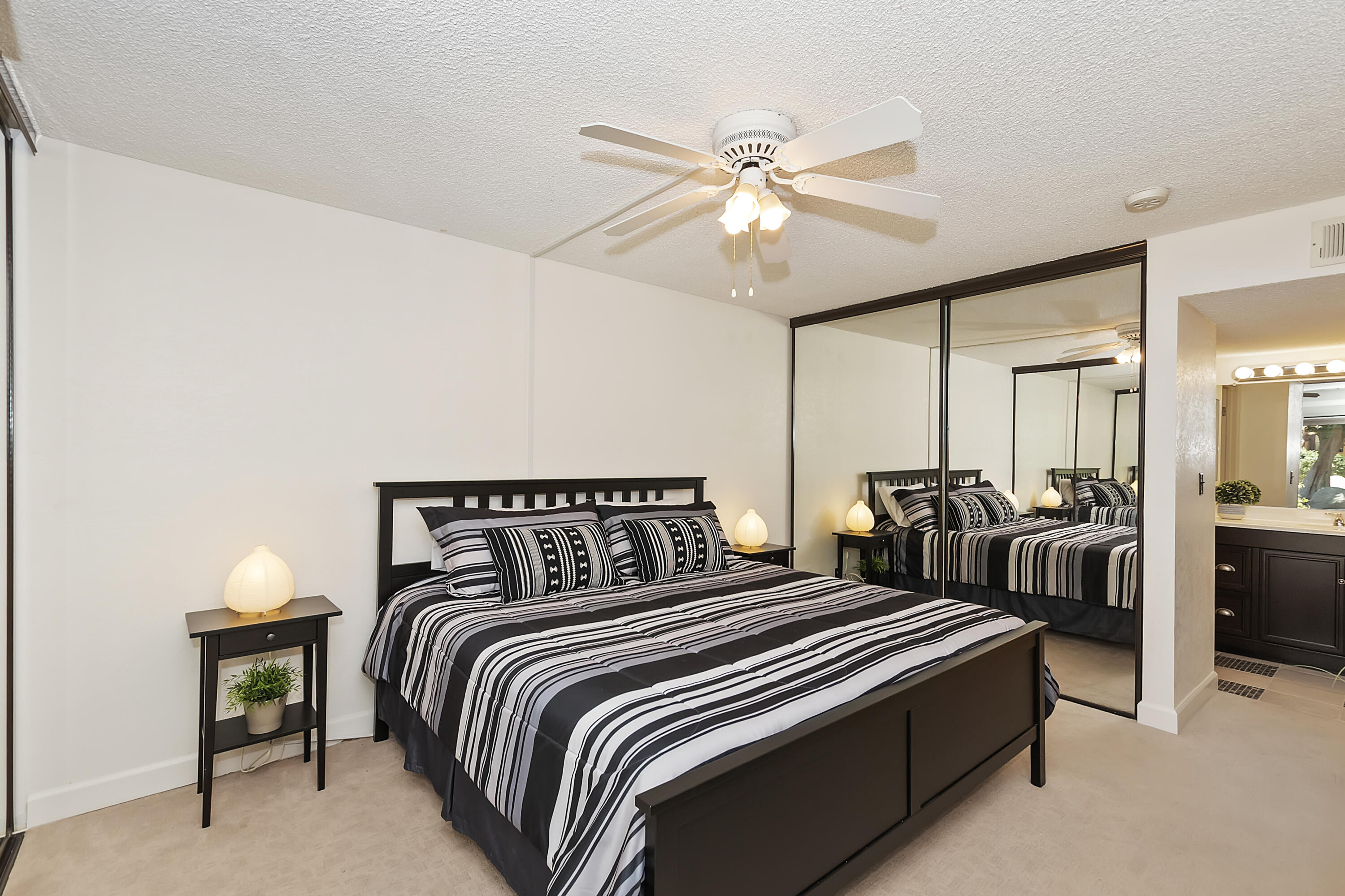 48255 Monroe Street, Unit 6 Indio, CA 92201 - Photo 9 of 43 a bedroom with two beds and a chandelier