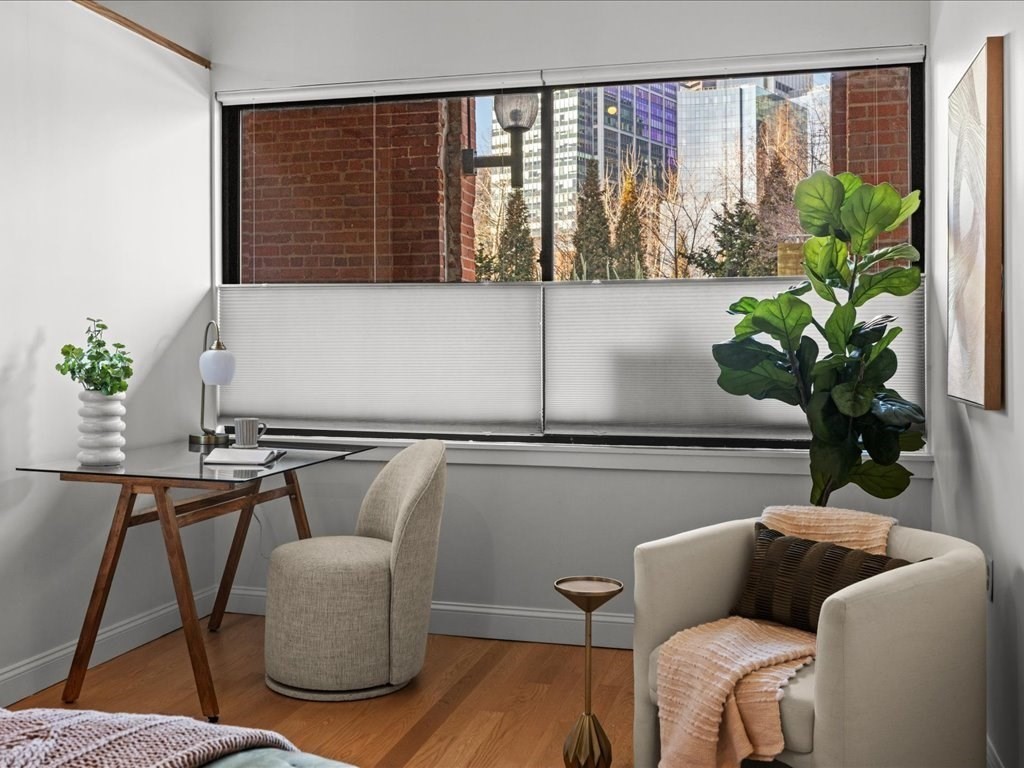 33 Sleeper Street, Unit 104 Boston, MA 02210 - Photo 12 of 23 a living room with furniture and a potted plant