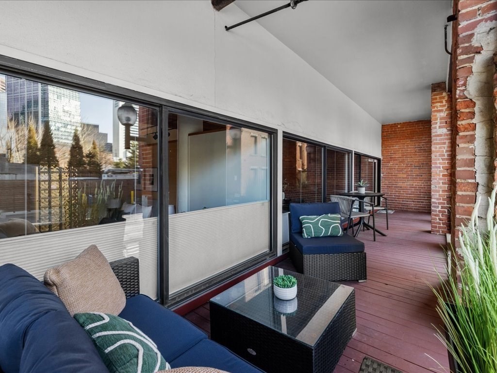33 Sleeper Street, Unit 104 Boston, MA 02210 - Photo 17 of 23 a living room with furniture and a large window