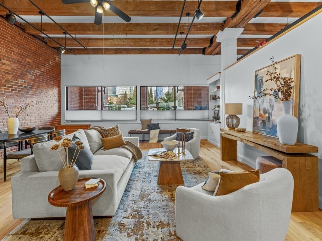 33 Sleeper Street, Unit 104 Boston, MA 02210 - Photo 5 of 23 a living room with furniture and a fireplace