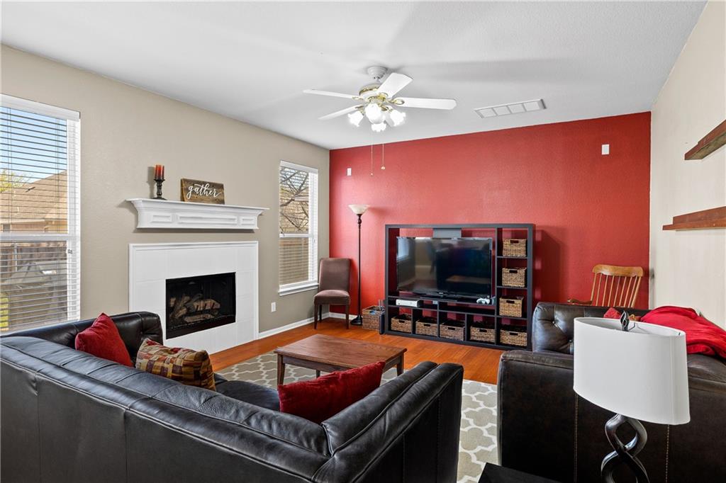3508 Bratton Ridge Crossing Austin, TX 78728 - Photo 5 of 18 Warm hardwood floors and a cozy fireplace create an inviting atmosphere for everyday living.
