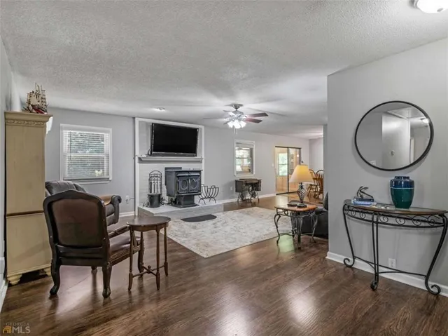 a living room with furniture a fireplace and a flat screen tv