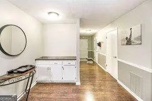 a view of a kitchen with wooden floor and a sink