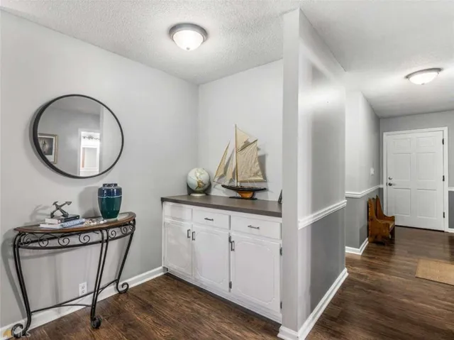 a very nice looking room with wooden floor and furniture