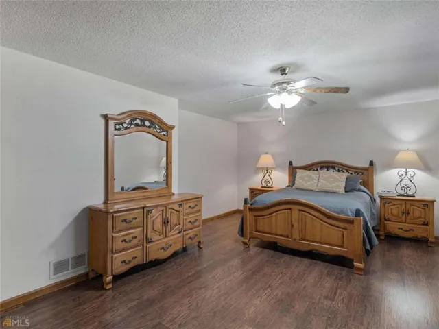 a bedroom with a bed dresser and a window