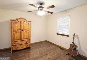 a bathroom with a granite countertop sink and a toilet