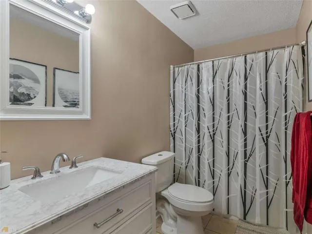 a bedroom with a bed and a lamp on table