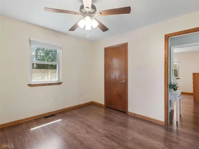 wooden floor in an empty room with a window