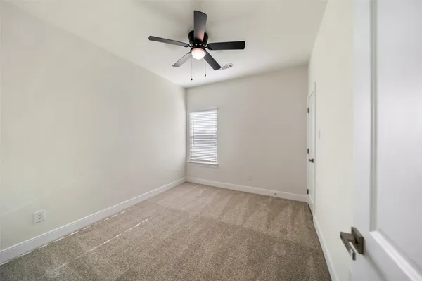 a view of room with a ceiling fan