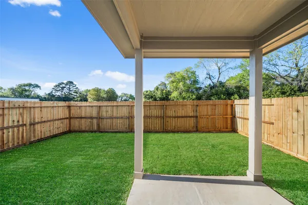 a view of a house with a yard and deck