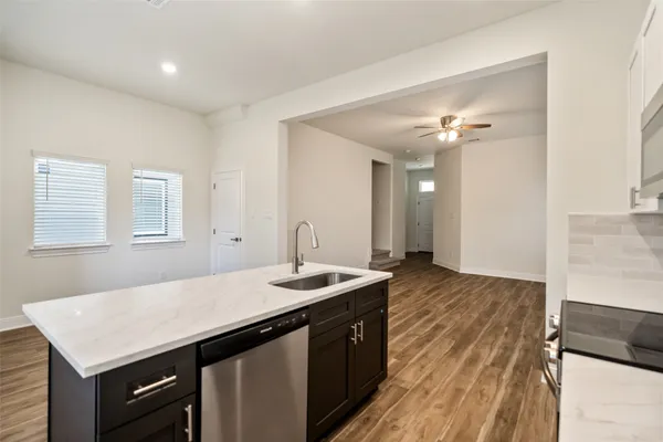 a kitchen with a sink dishwasher and a stove