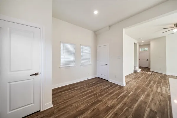 a view of a room with wooden floor