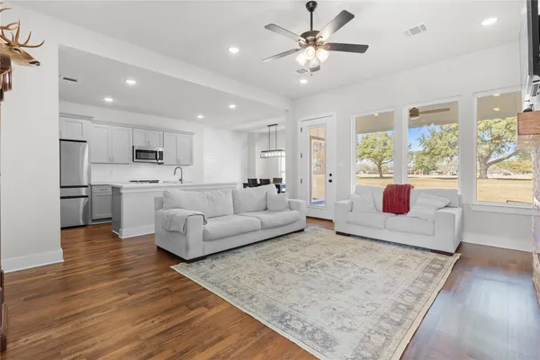 a living room with furniture and a large window