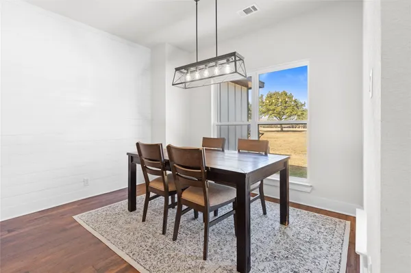 a view of a dining room with furniture and a chandelier