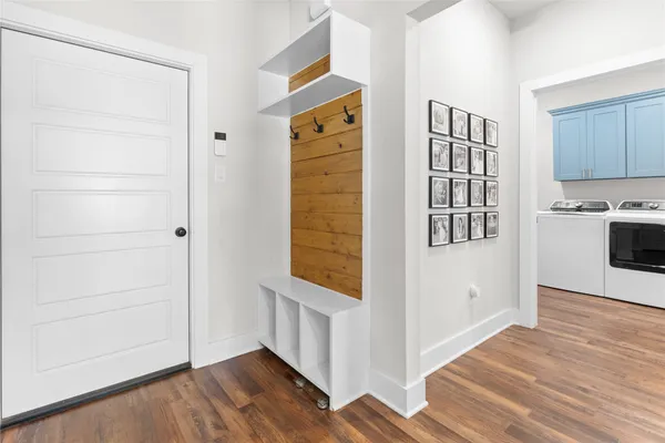 a view of a hallway with wooden floor and closet