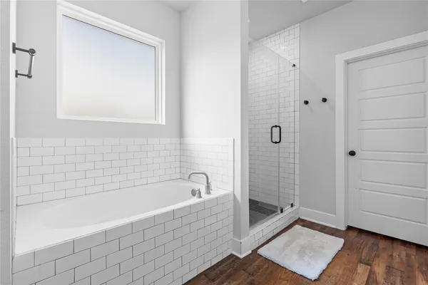 a bathroom with a bathtub and shower