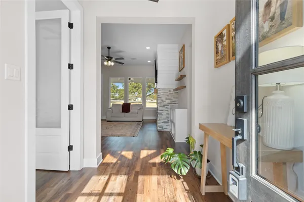 a hallway with a dining table and chairs