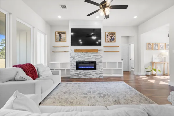 a living room with furniture and a fireplace