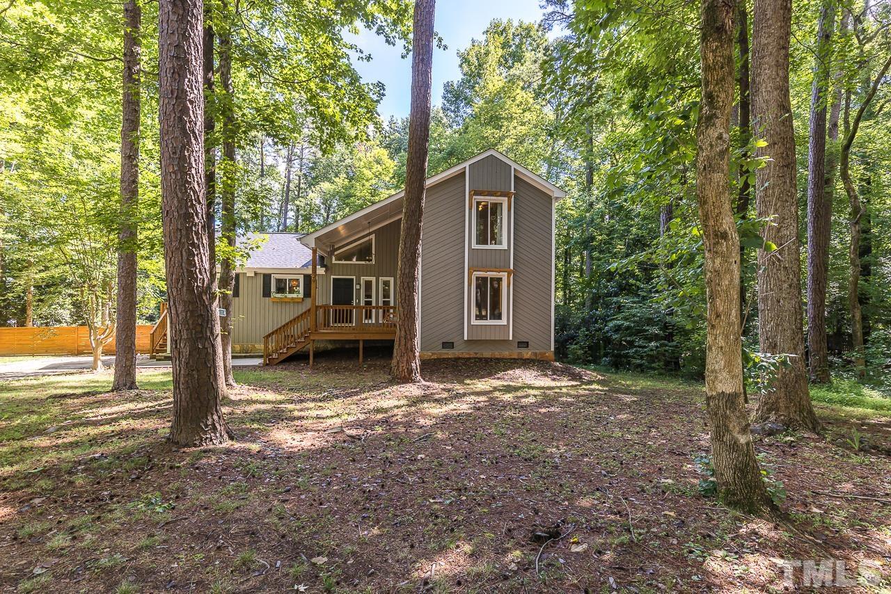 7929 Kingsland Drive Raleigh, NC 27613 - Photo 1 of 46 a view of a house with backyard and trees