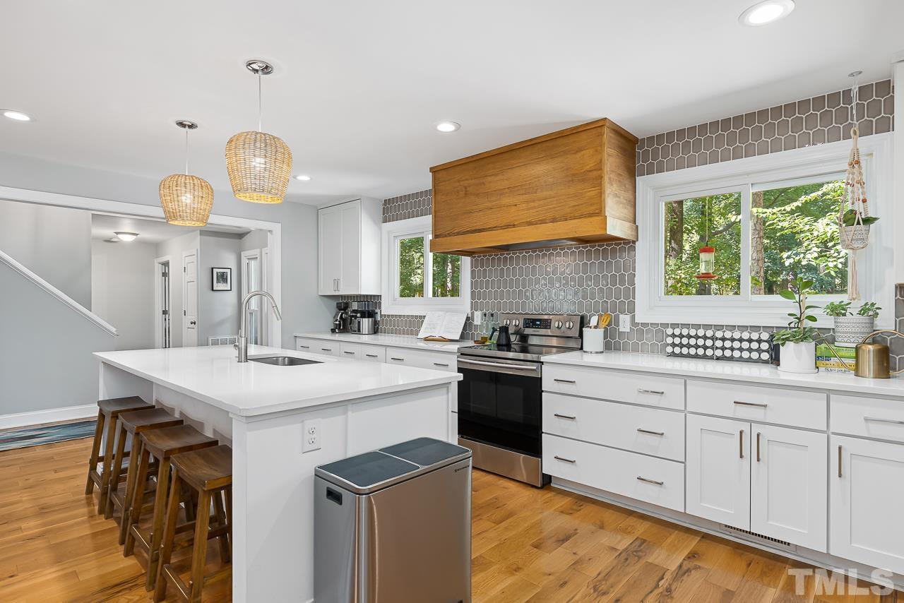 7929 Kingsland Drive Raleigh, NC 27613 - Photo 13 of 46 a kitchen with a sink stove and cabinets