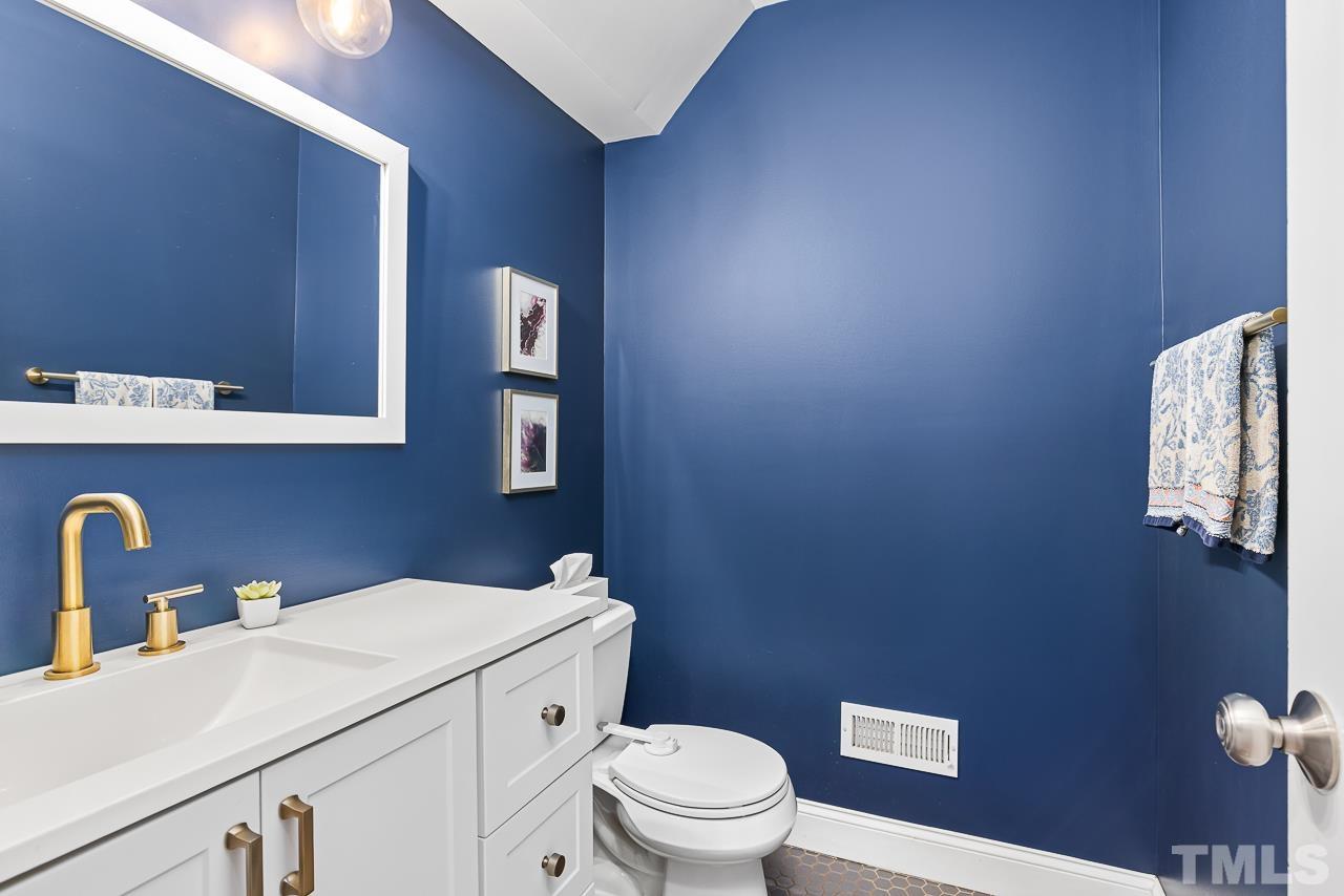 7929 Kingsland Drive Raleigh, NC 27613 - Photo 17 of 46 a bathroom with a sink a toilet and mirror