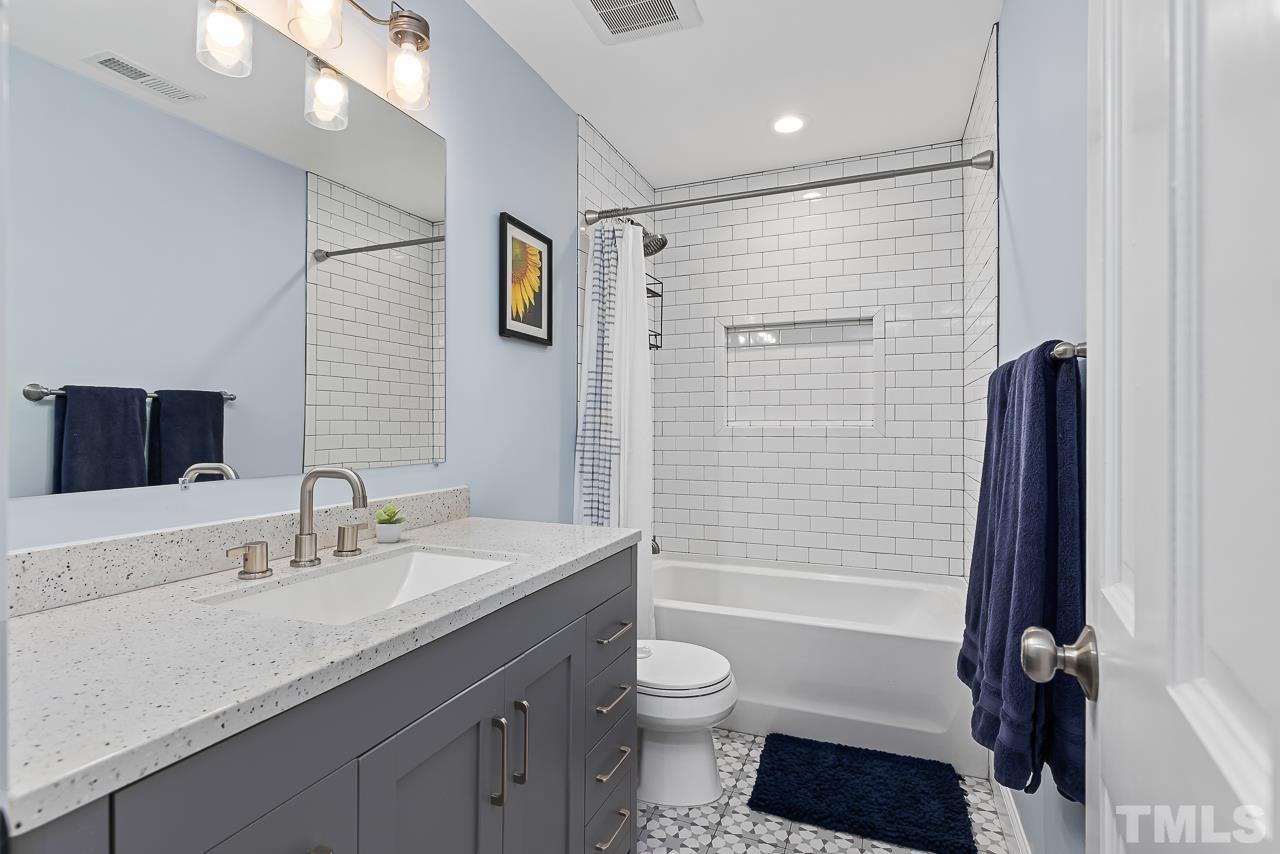 7929 Kingsland Drive Raleigh, NC 27613 - Photo 26 of 46 a bathroom with a granite countertop sink toilet and shower