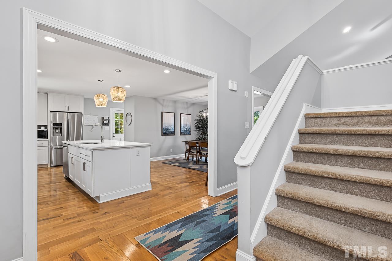7929 Kingsland Drive Raleigh, NC 27613 - Photo 5 of 46 a view of kitchen and hall with wooden floor