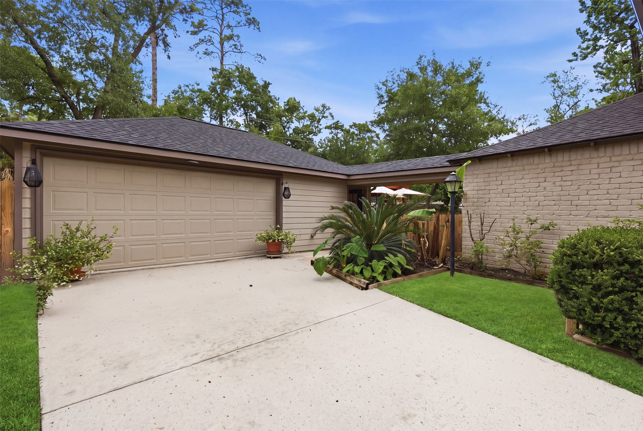 6126 Hickorycrest Drive Spring, TX 77389 - Photo 26 of 50 Wide driveway leading to the garage with clean exterior and landscaped entry.