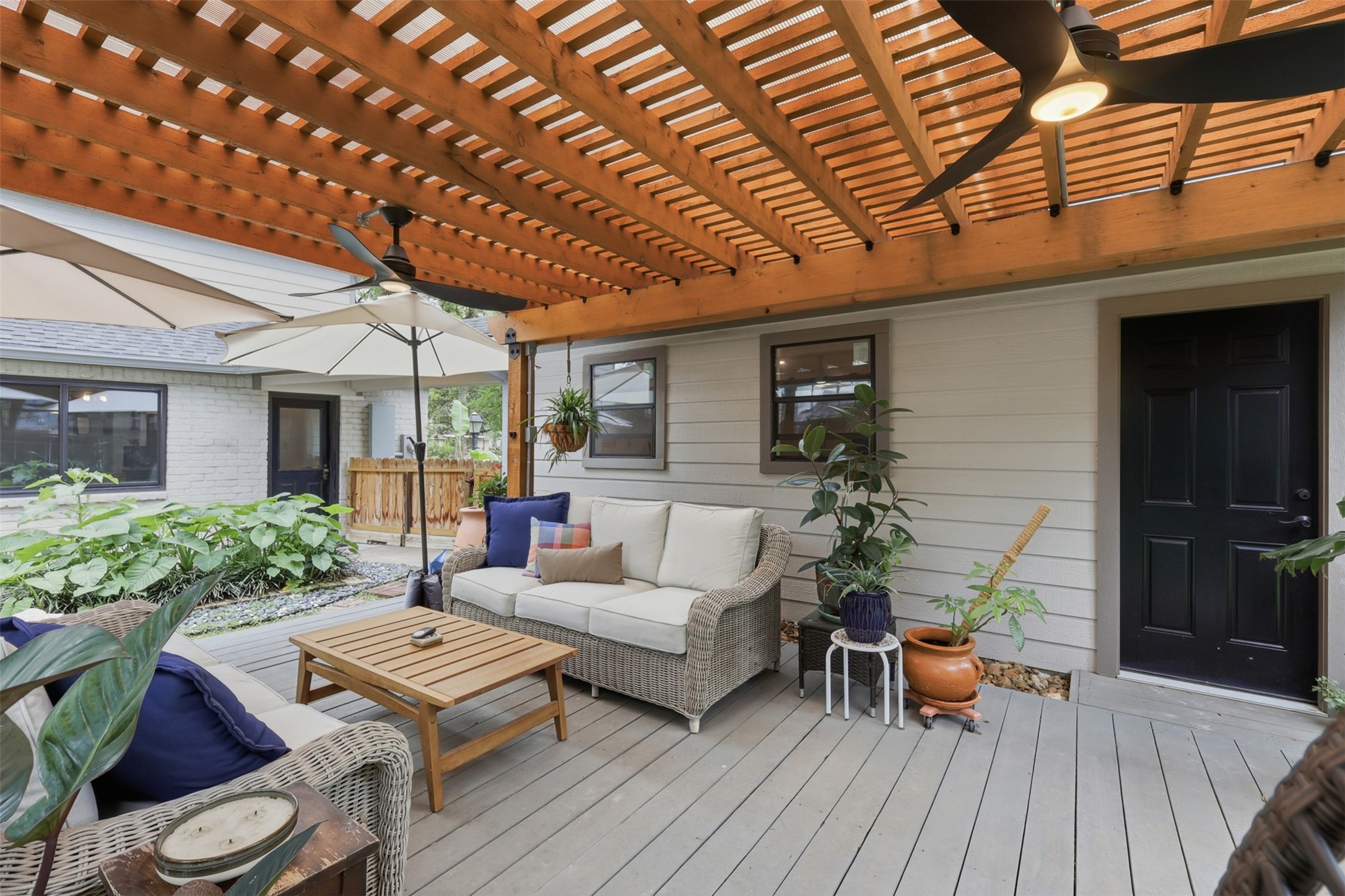 6126 Hickorycrest Drive Spring, TX 77389 - Photo 31 of 50 Covered patio with seating area, ceiling fans, and a great setup for relaxing or entertaining.