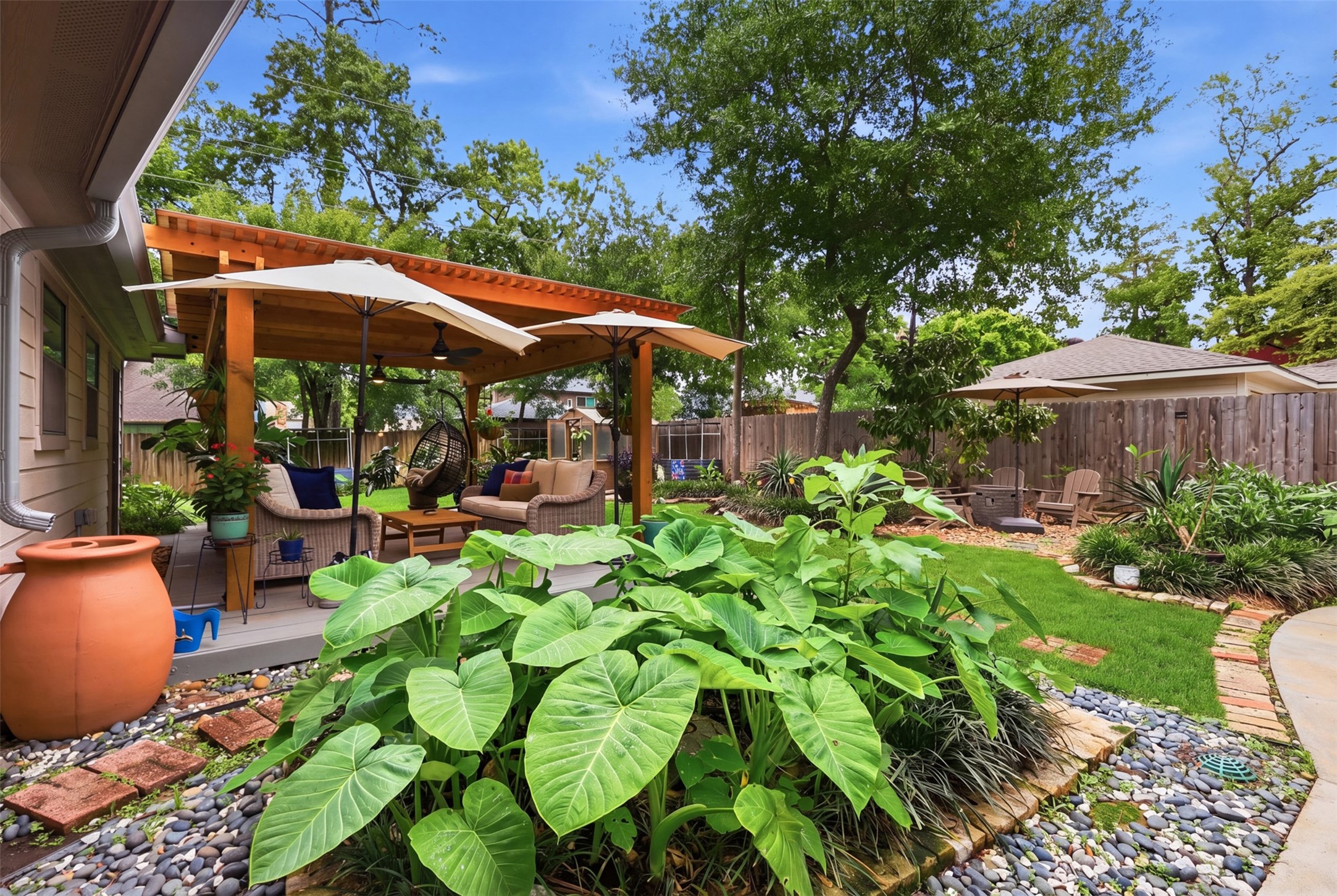 6126 Hickorycrest Drive Spring, TX 77389 - Photo 34 of 50 Beautiful backyard view with covered patio, lush landscaping, and multiple areas to enjoy the outdoors.