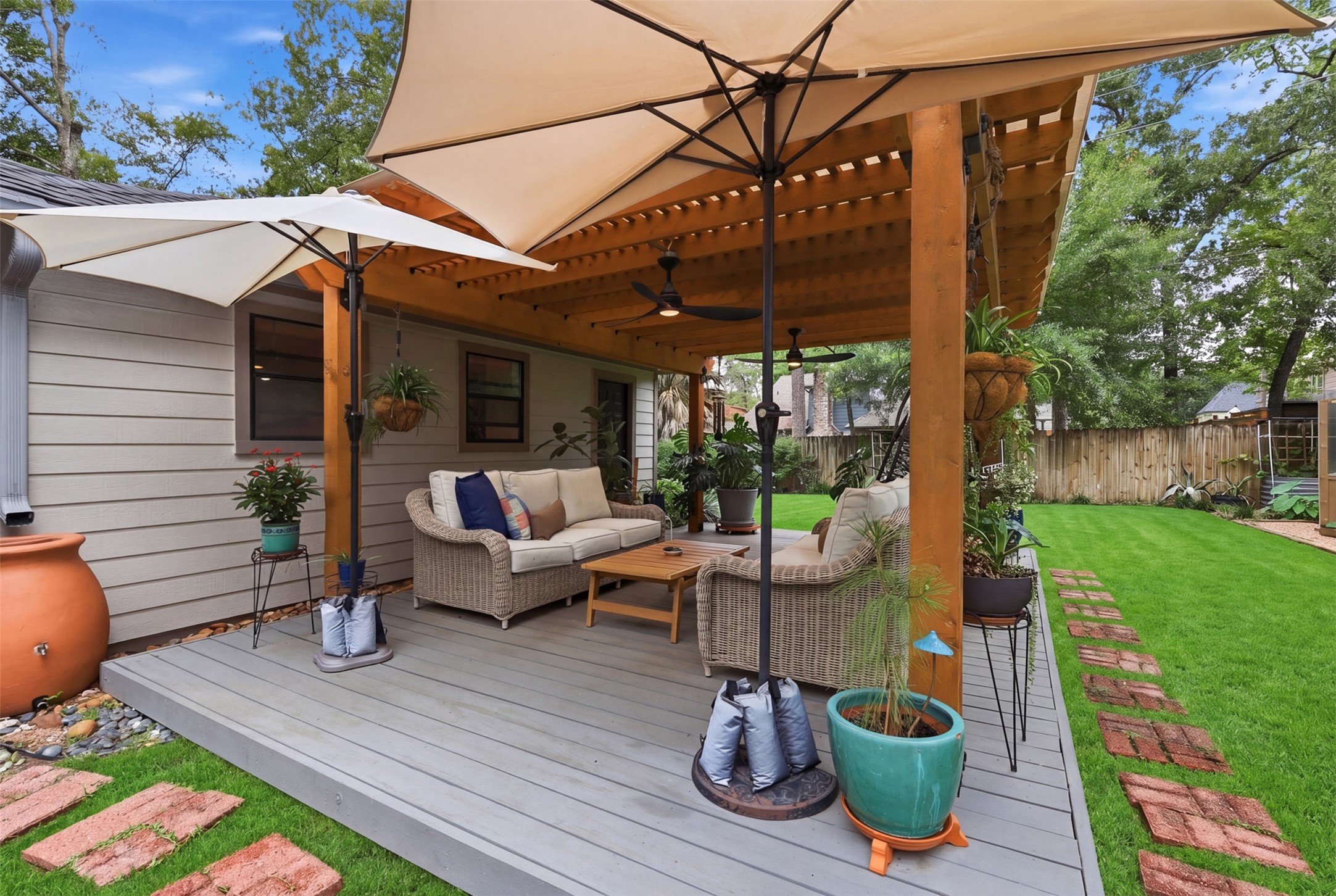 6126 Hickorycrest Drive Spring, TX 77389 - Photo 37 of 50 Covered deck with ceiling fans and a comfortable space to relax outdoors.