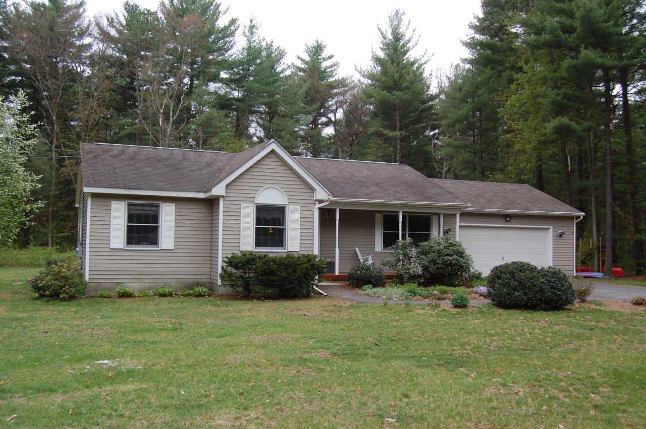 a view of a house with a yard and plants