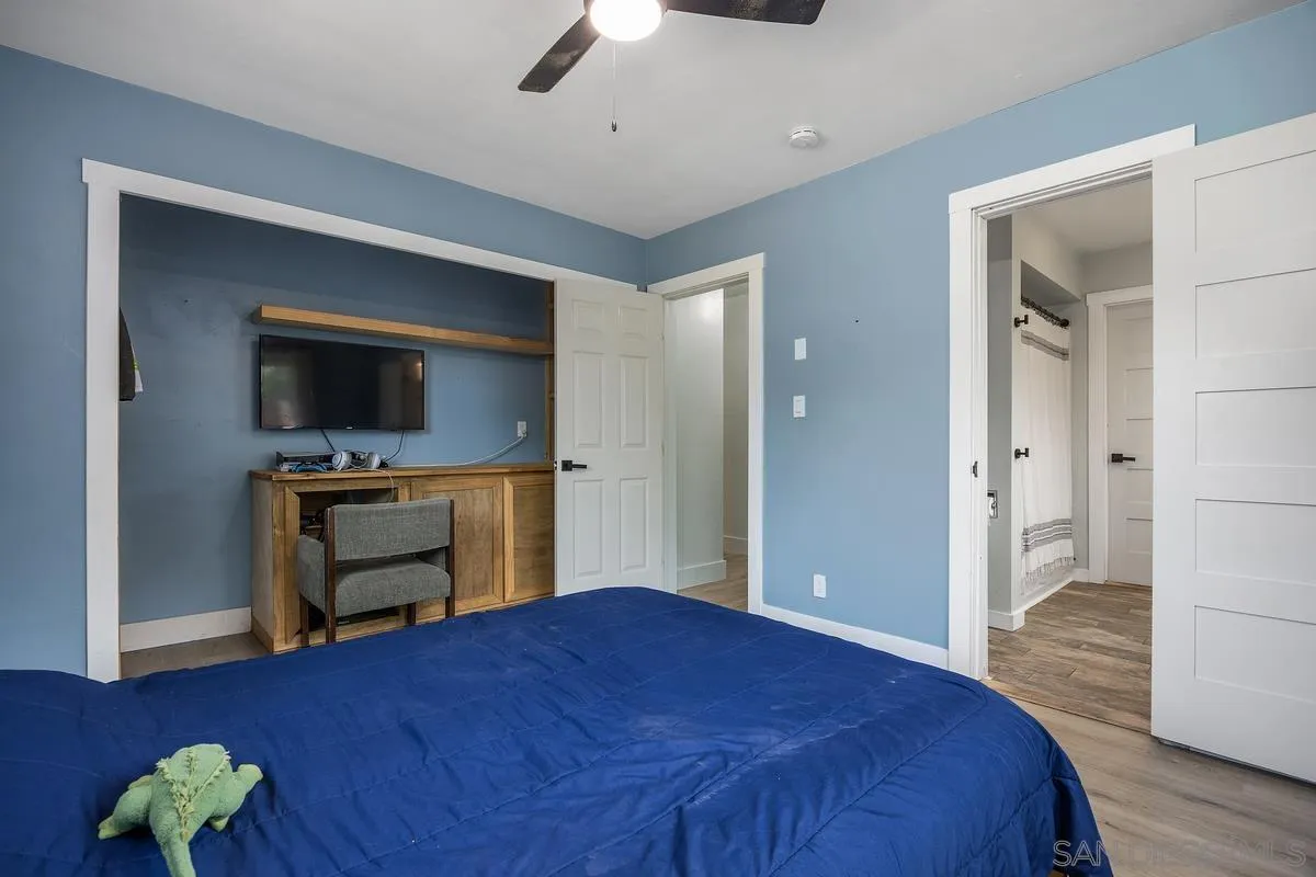 1211 East Mission Road Fallbrook, CA 92028 - Photo 23 of 31 a bedroom with a bed and a flat screen tv