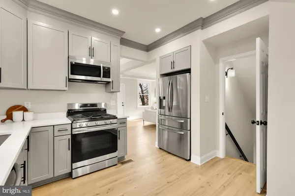 a kitchen with stainless steel appliances a stove a microwave and a refrigerator