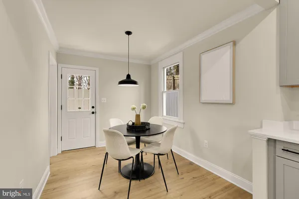 a dining room with furniture and wooden floor