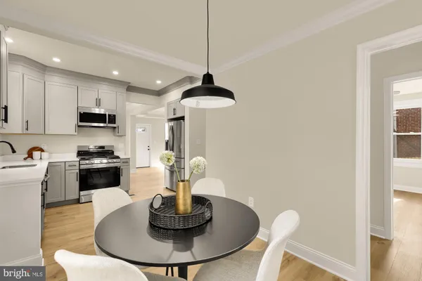 a kitchen with a table and chairs