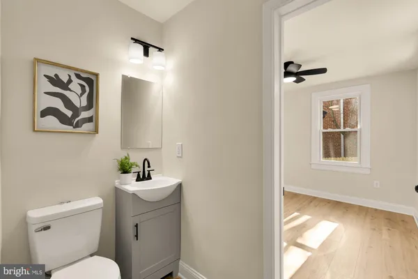 a bathroom with a sink mirror and toilet