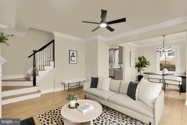 a living room with furniture and a view of kitchen