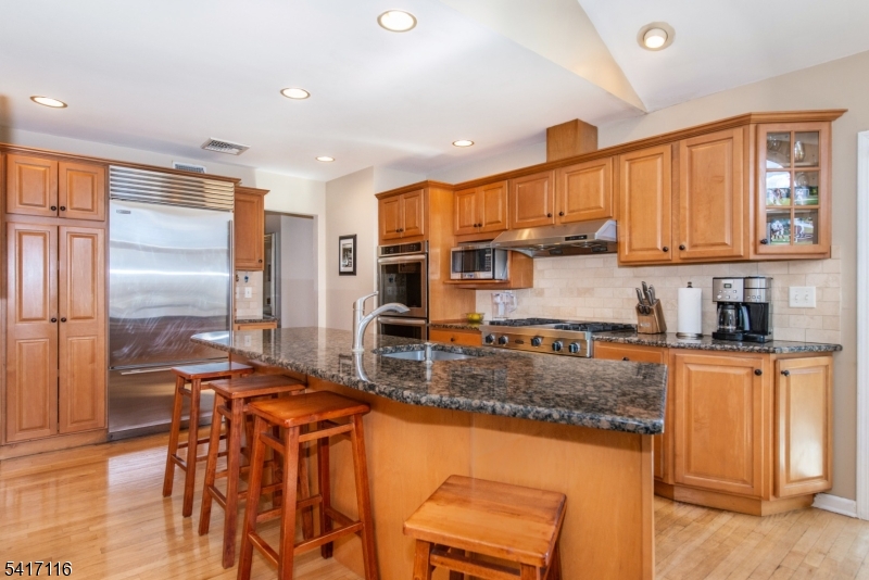 29 Long Acres Road Fairfield, NJ 07004 - Photo 12 of 33 a kitchen with stainless steel appliances granite countertop a stove top oven a sink and a refrigerator