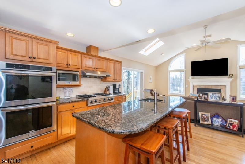 29 Long Acres Road Fairfield, NJ 07004 - Photo 13 of 33 a kitchen with stainless steel appliances granite countertop a stove and a microwave